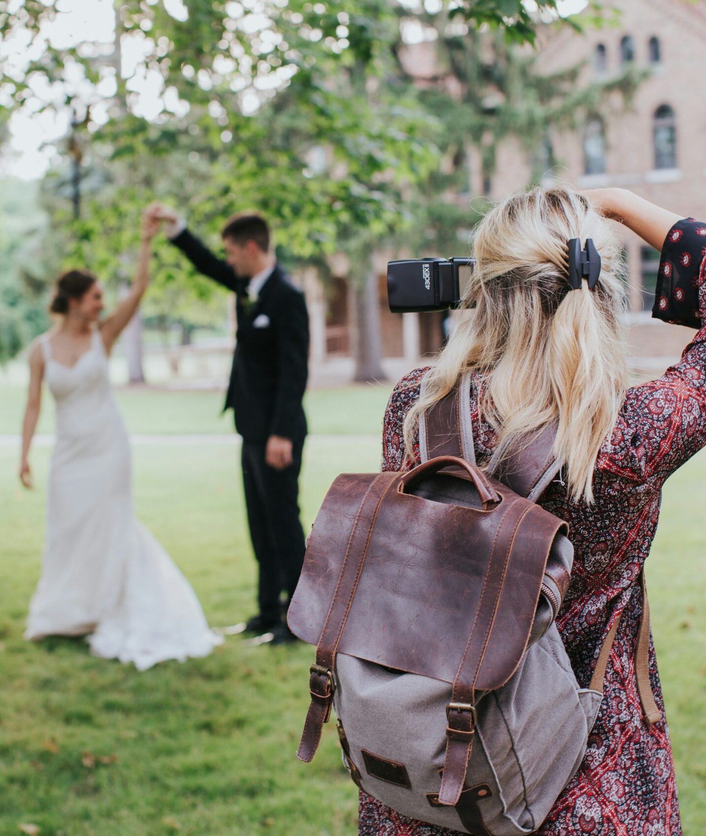 A wedding photographer that needs a standout wedding photographer brand taking a photo of a couple
