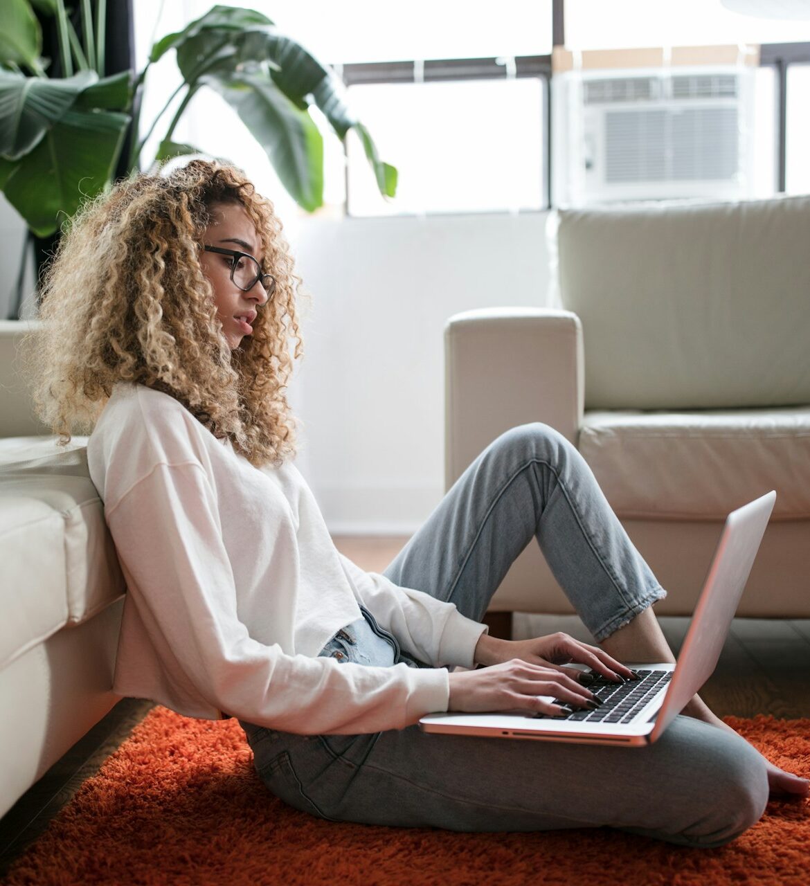 Woman entrepreneur reviewing website design cost estimates on a laptop