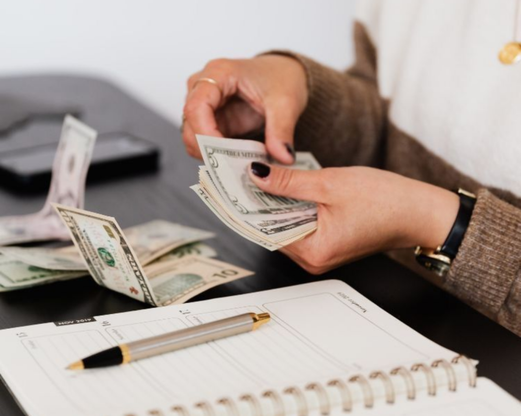 Woman budgeting and detailing the breakdown for web design for small businesses cost.